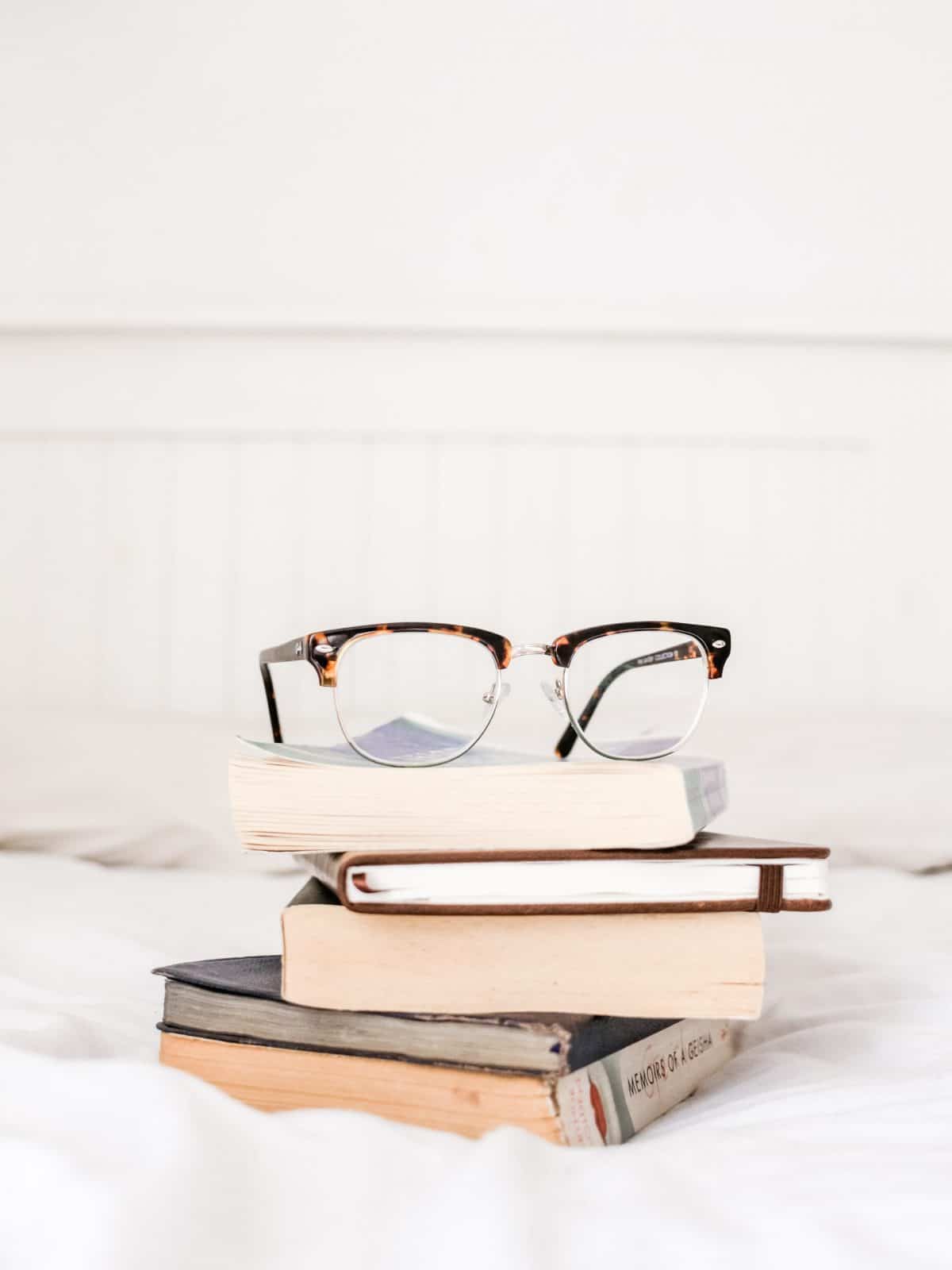 glasses on a pile of books