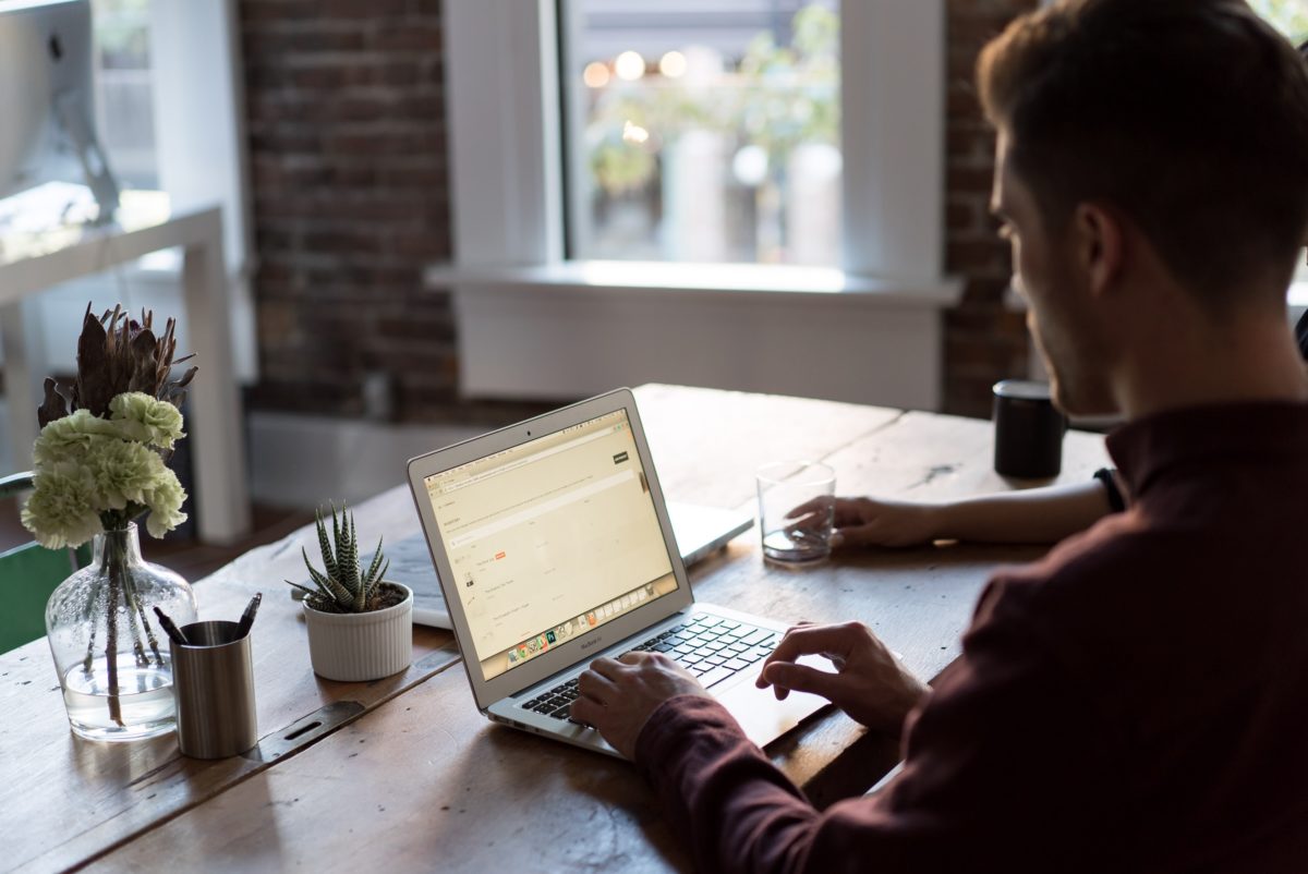 Man working on laptop on bench