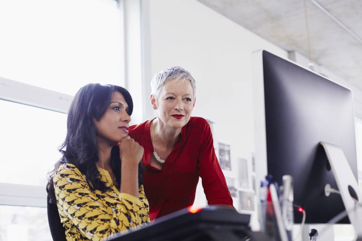 Two people working on a computer