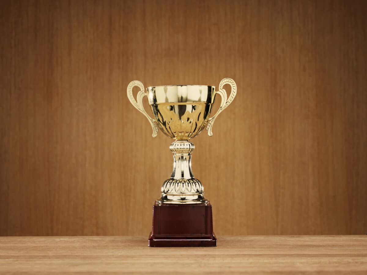 Trophy on wooden background. Platinum award.